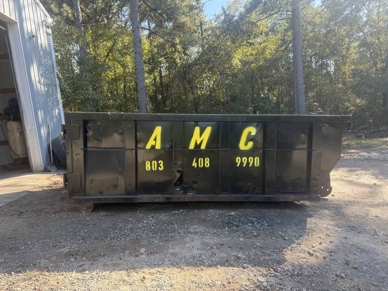 An AMC Waste Services roll-off dumpster ready for a garage cleanout