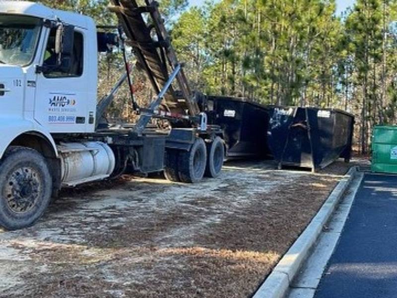 An AMC Waste Services row of roll-off dumpsters ready to go out in Sumter, Sumter County, SC
