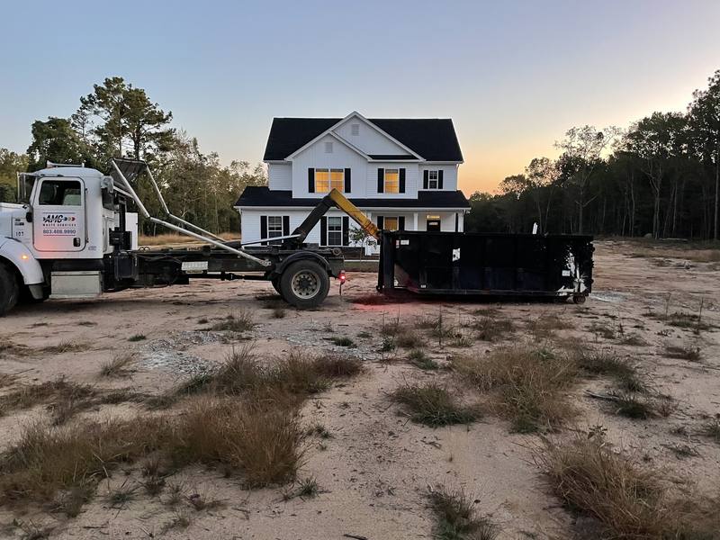 A large roll-off dumpster on a new home build