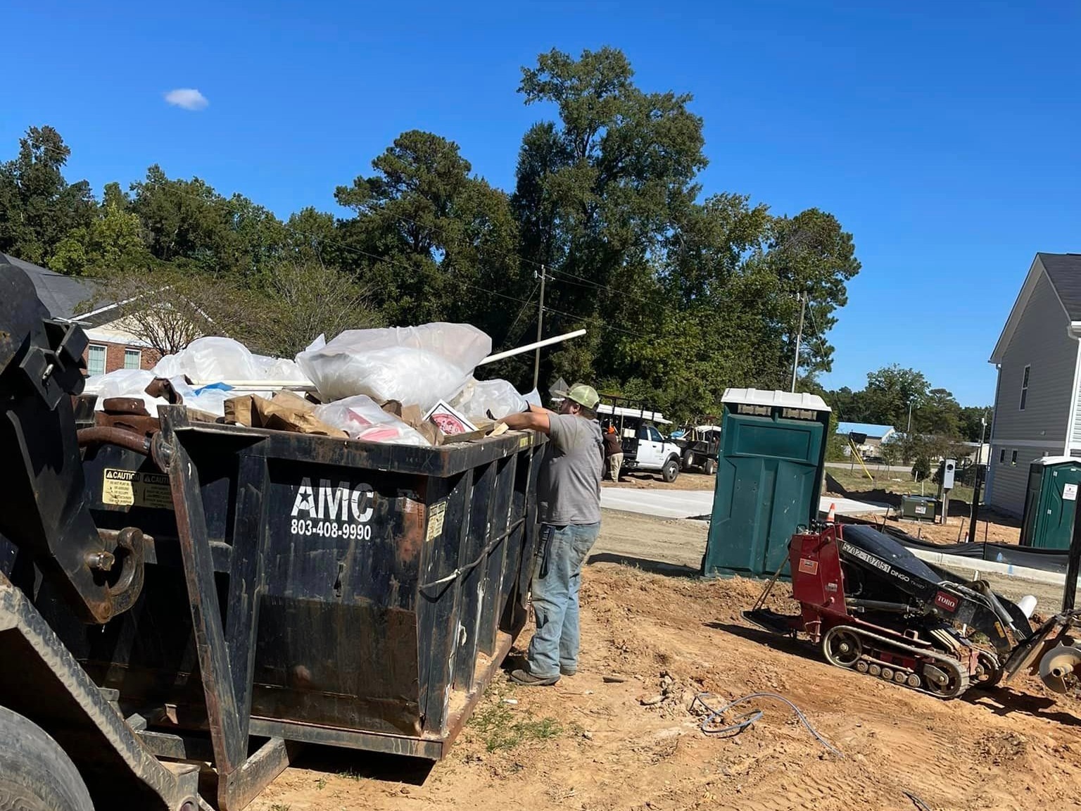 An AMC Waste Services roll-off dumpster on a job in the Columbia, SC Midlands