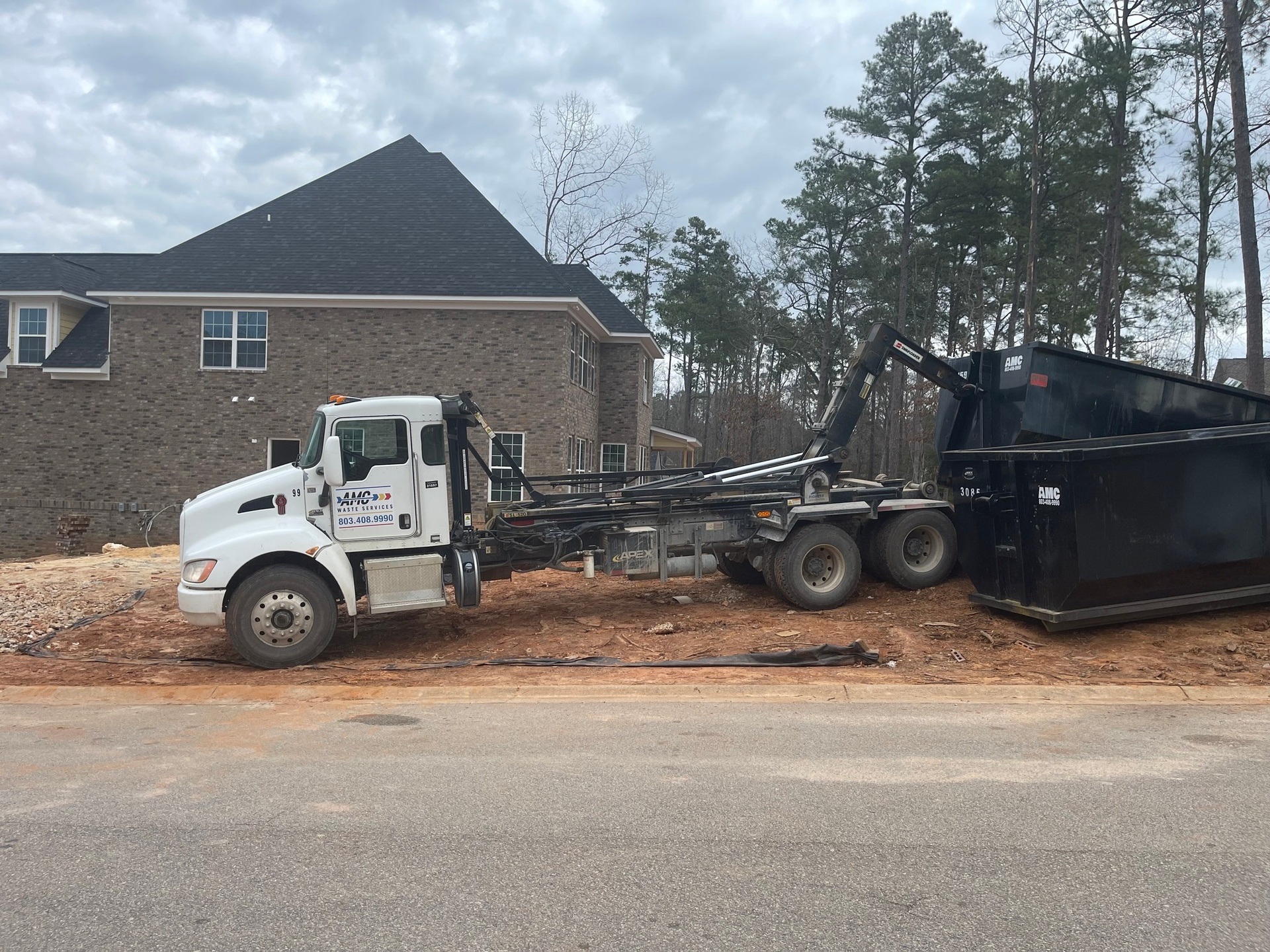 An AMC Waste Services roll-off dumpster on a job in the Columbia, SC Midlands