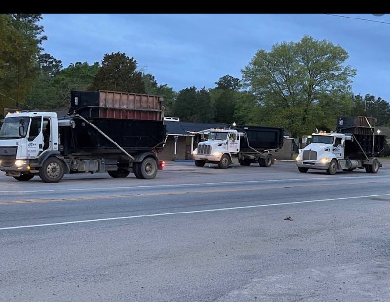 Three AMC Waste Services trucks rolling out for morning deliveries